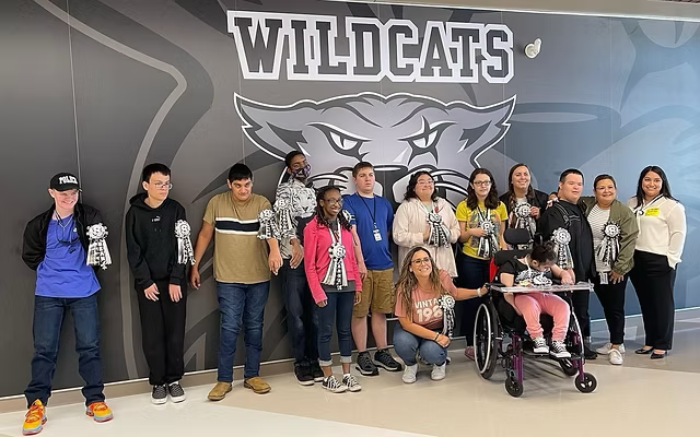 Students and staff with donated homecoming mums and garters